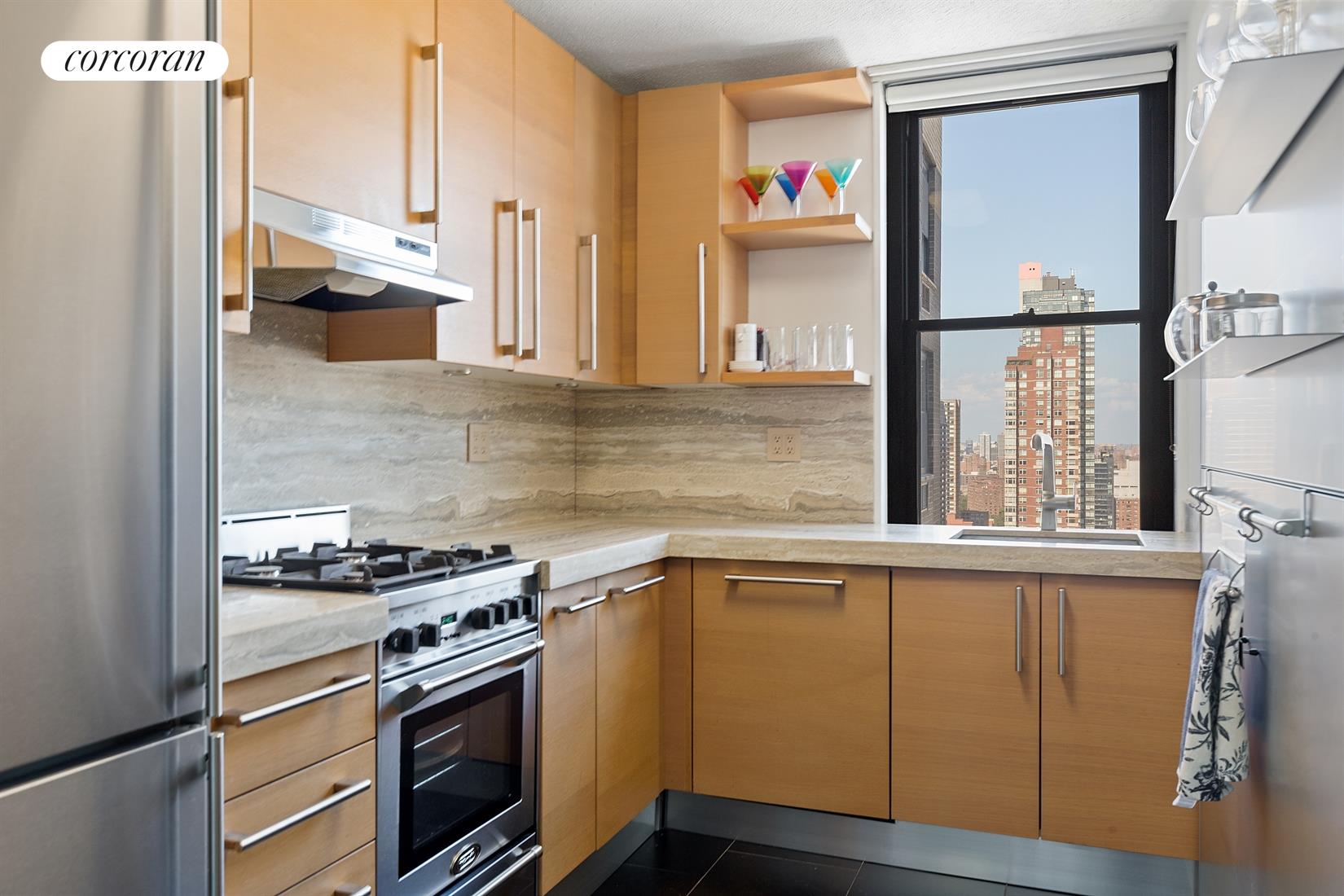 a kitchen with stainless steel appliances granite countertop a stove and a refrigerator