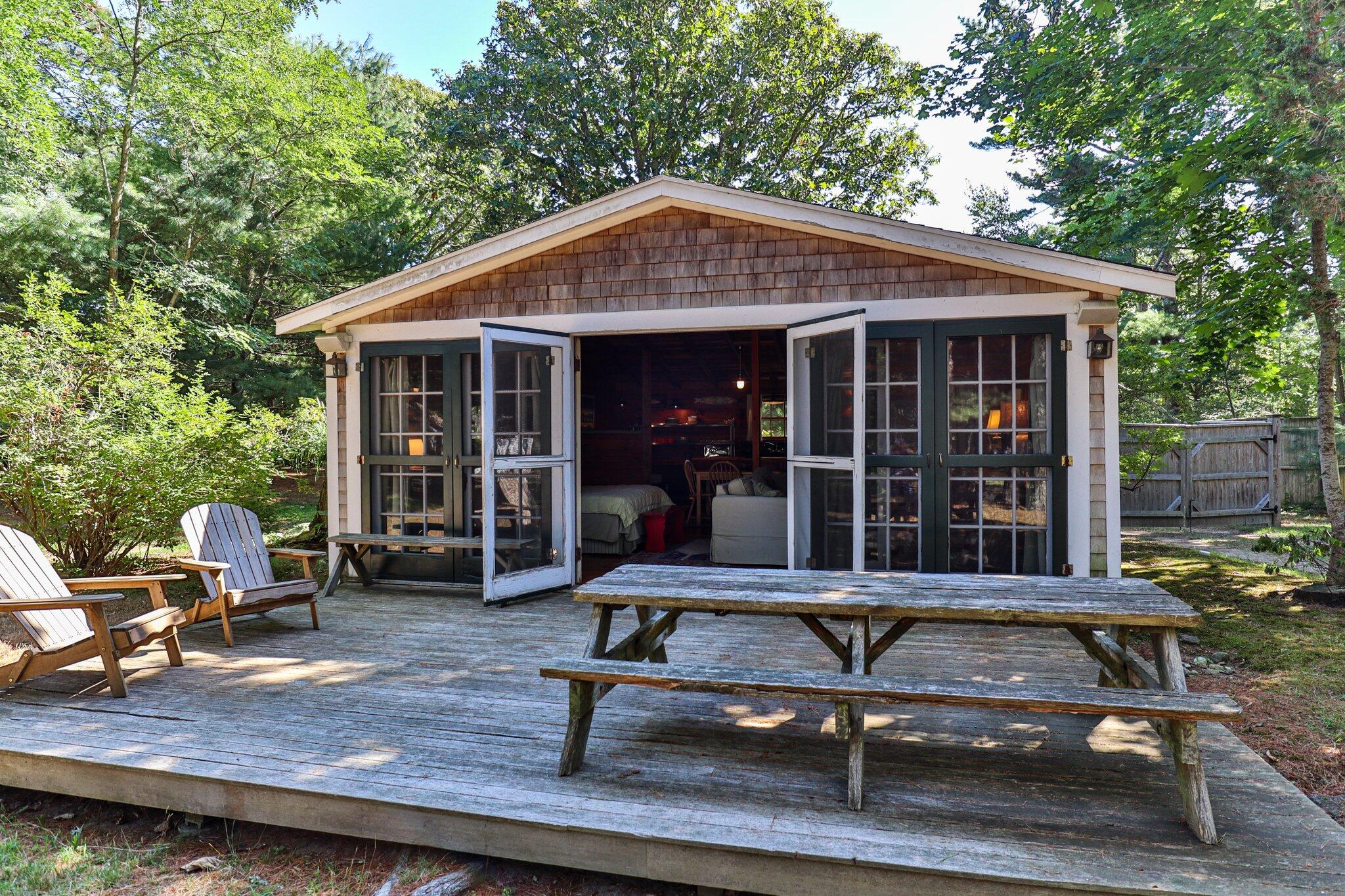 a view of a house with backyard sitting area and garden