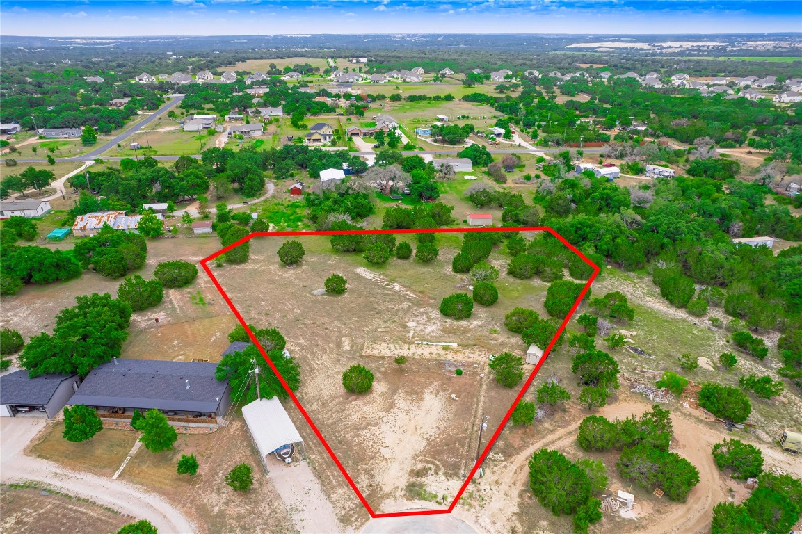 an aerial view of a house with a yard