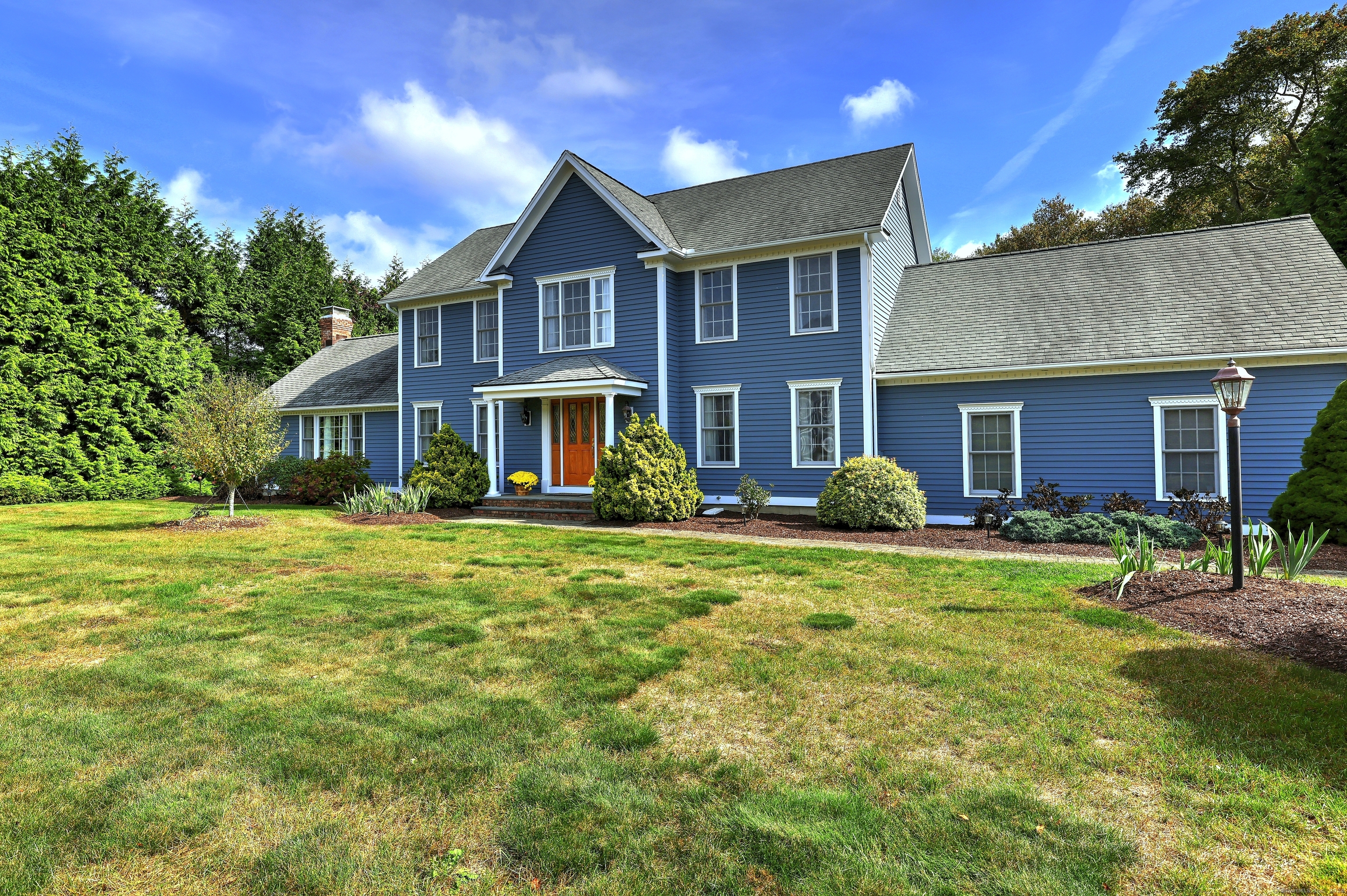 a front view of a house with a garden