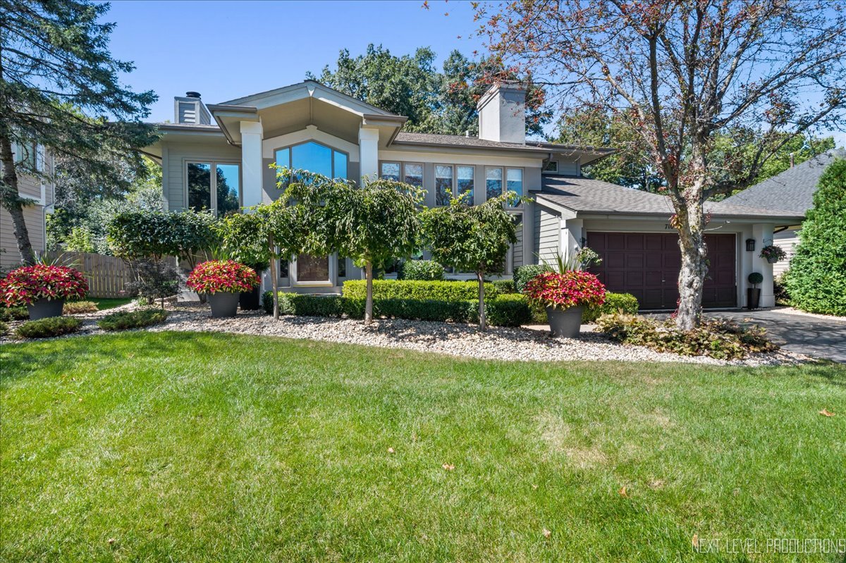 a front view of house with yard and green space