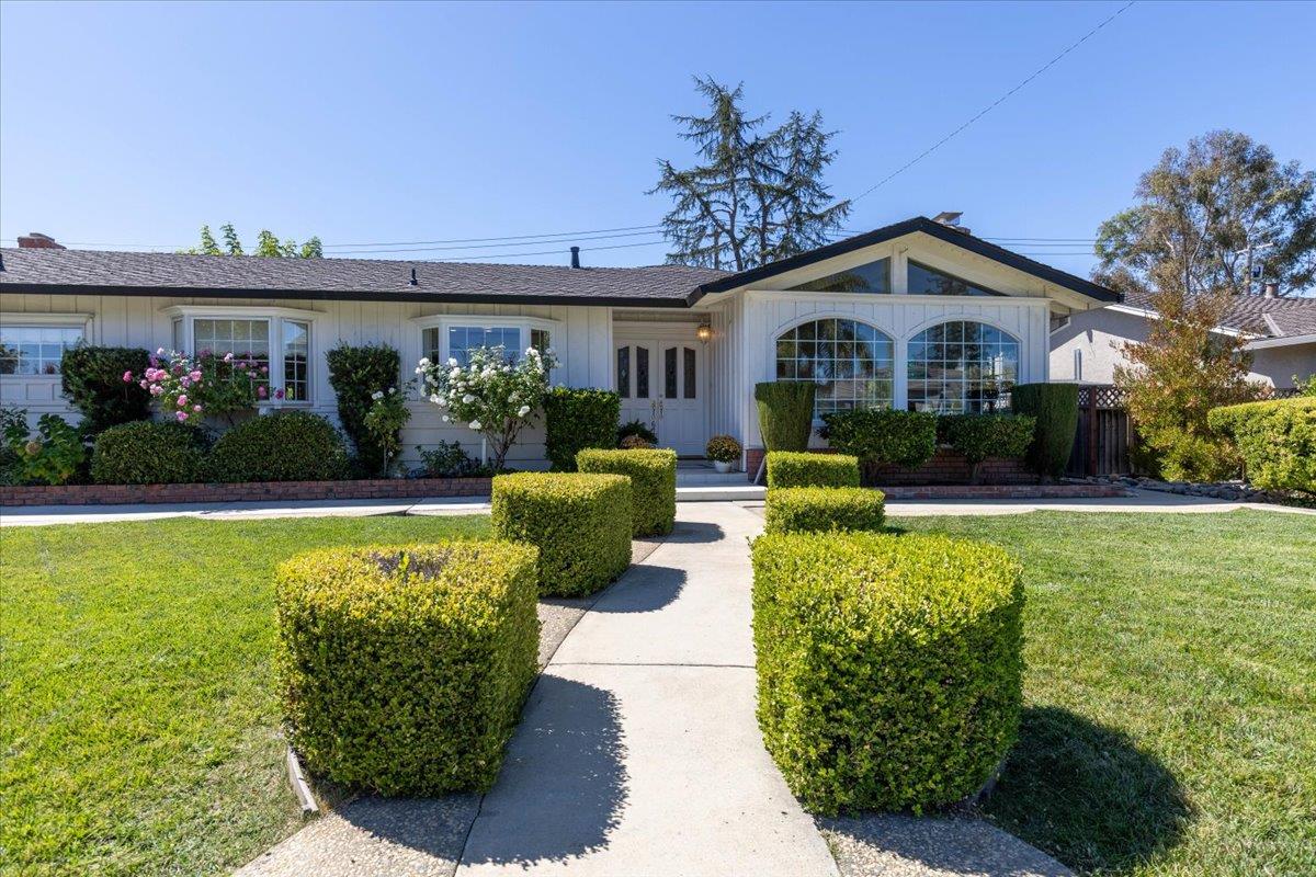 a front view of a house with garden