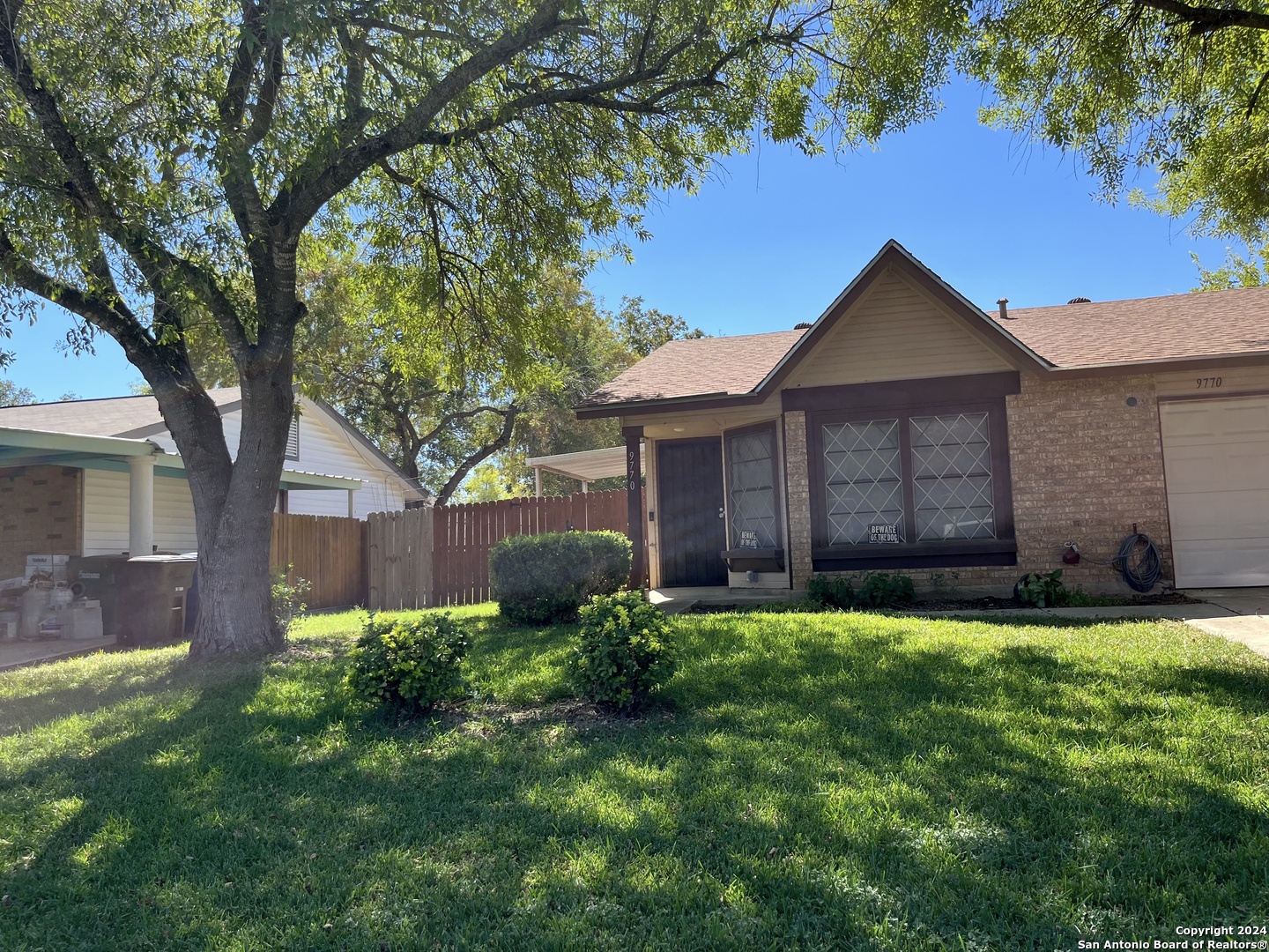 a house with a yard and a large tree