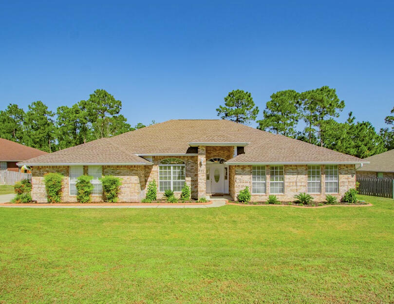 a front view of a house with garden