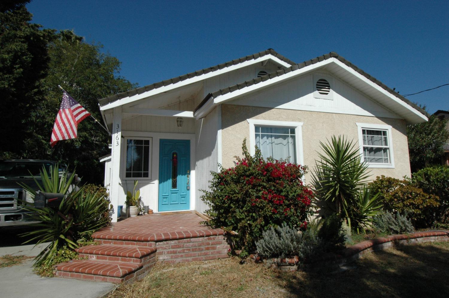 a front view of a house with garden