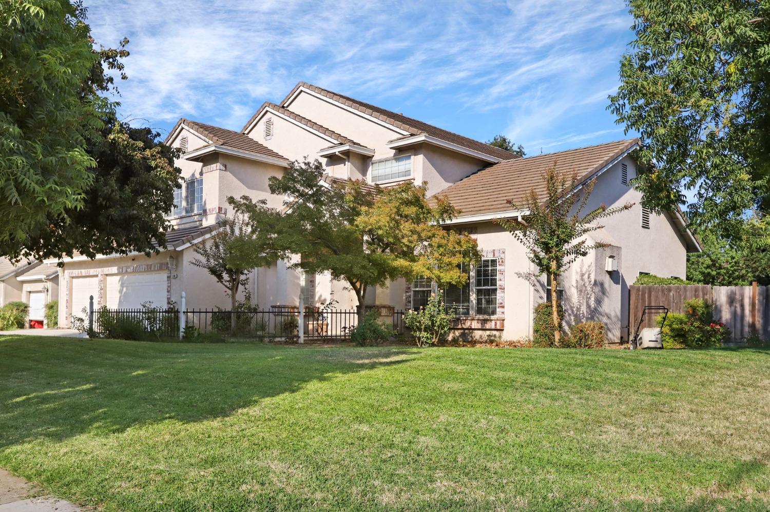 a front view of house with a garden