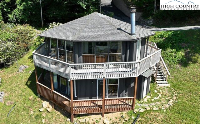 a view of house with deck and garden