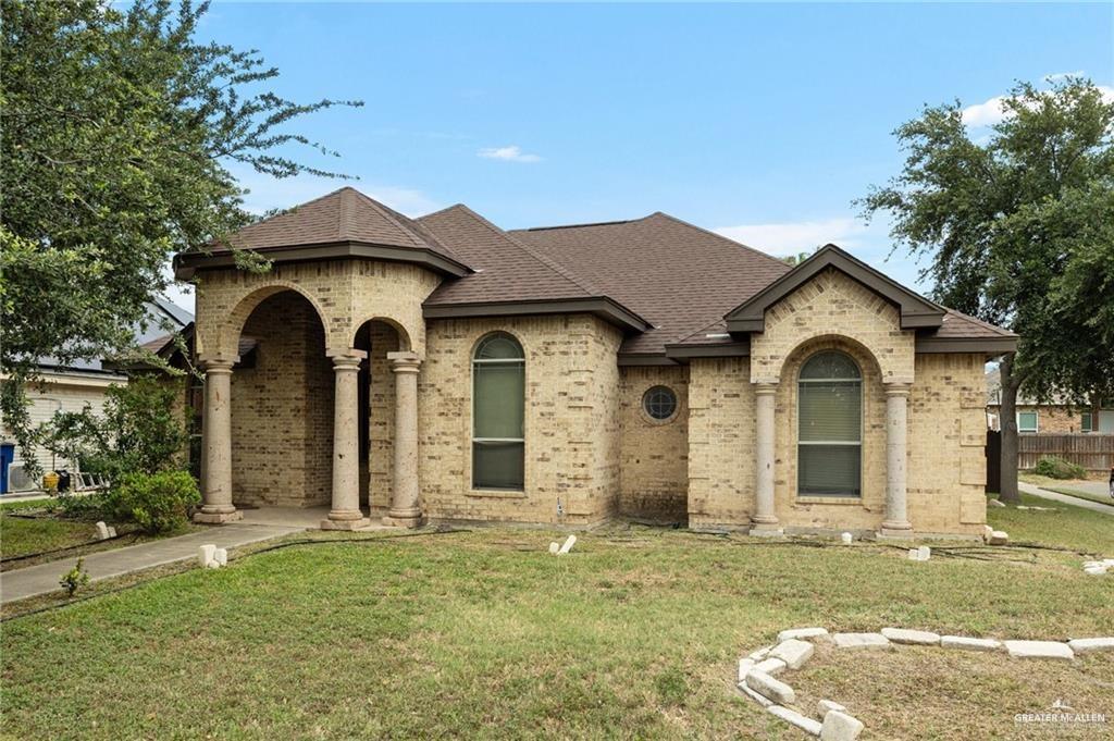 French country inspired facade featuring a front yard