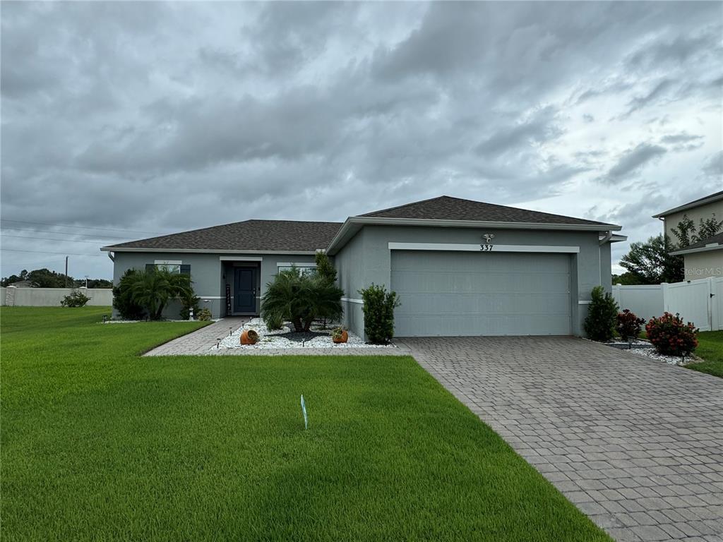 a view of a house with a yard and sitting area