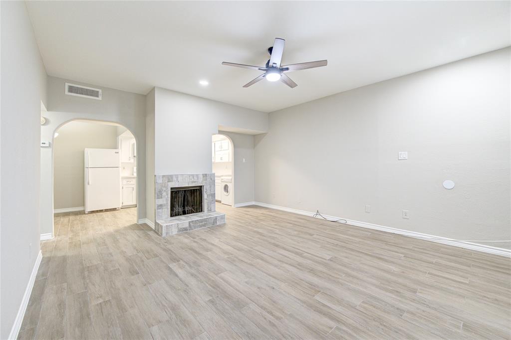 a view of a room wooden floor and fireplace