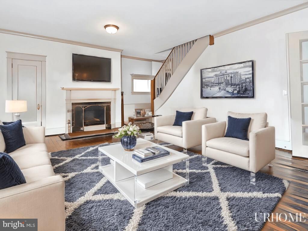 a living room with furniture a rug and a fireplace