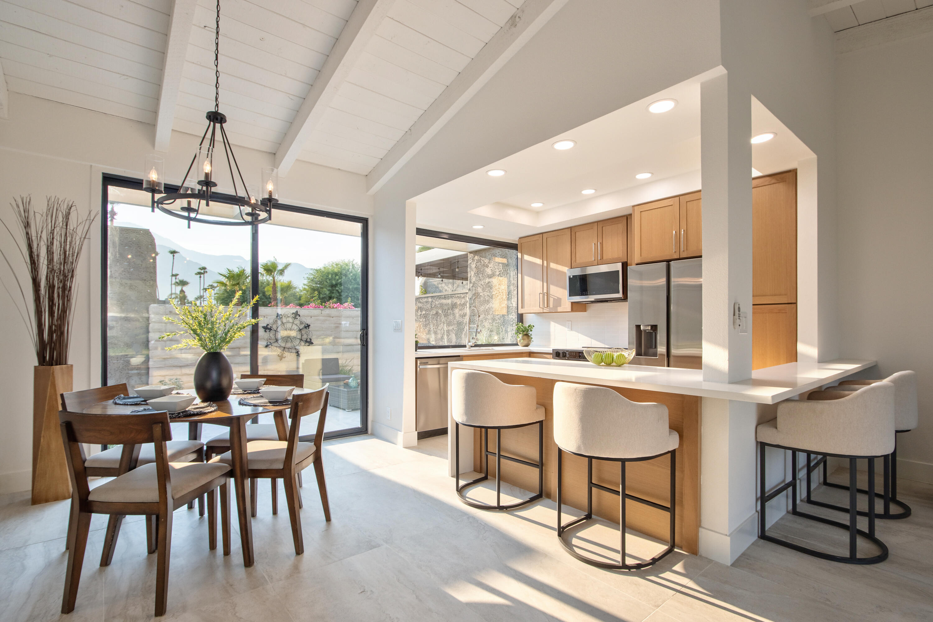 a kitchen with a table chairs stove and cabinets