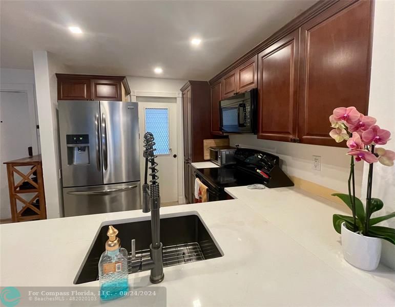 a kitchen with a refrigerator and a sink