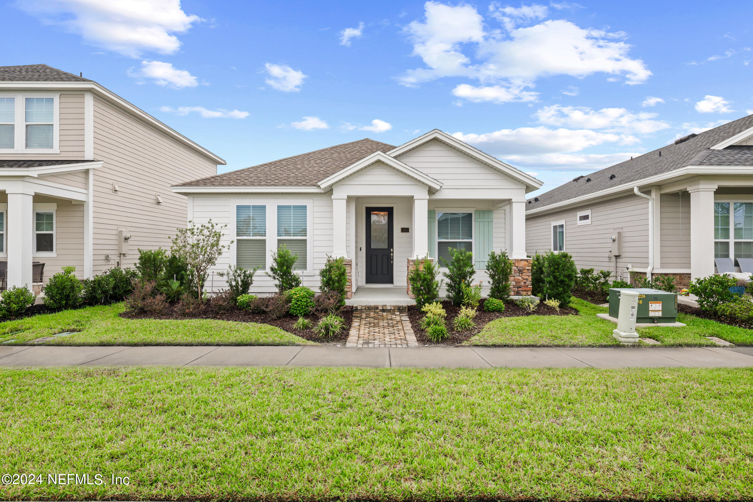 a front view of a house with a garden