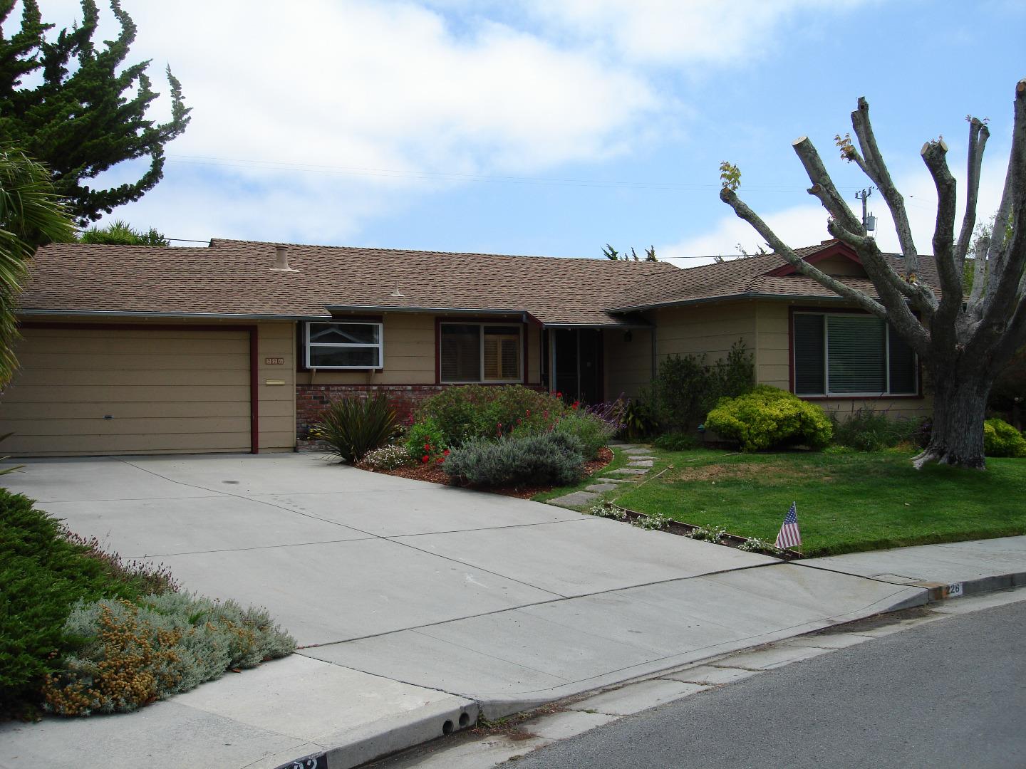 a front view of a house with a garden