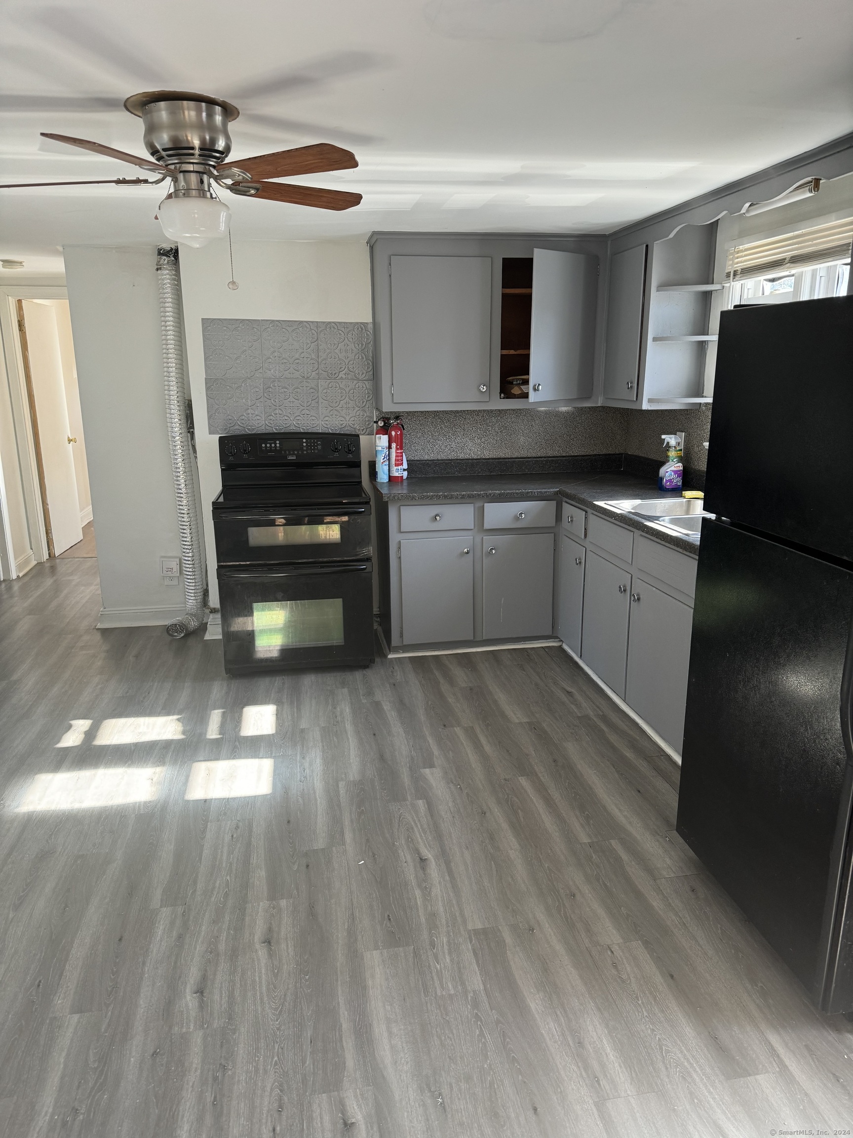 a kitchen that has a lot of cabinets and appliances