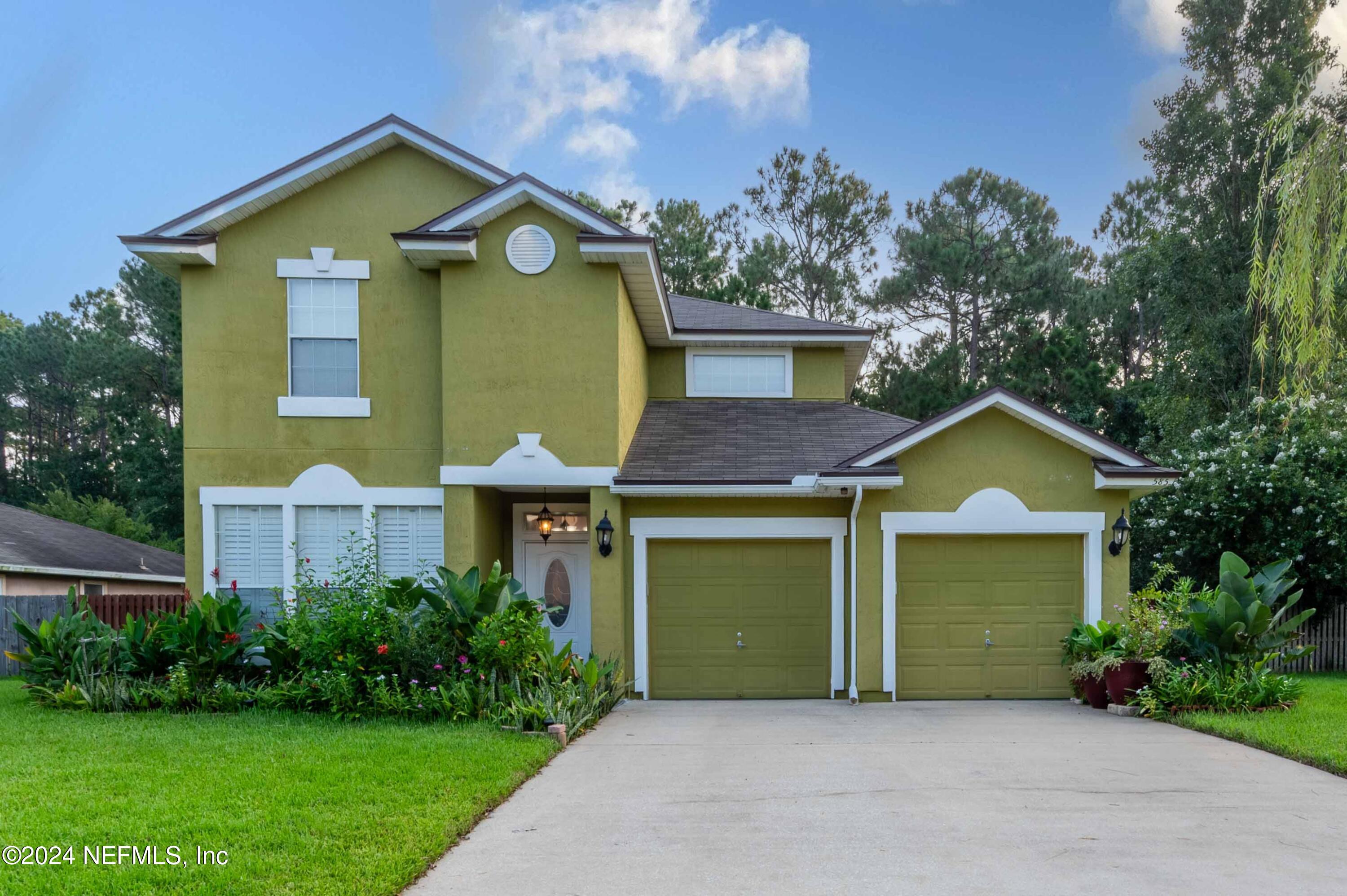 a front view of a house with garden