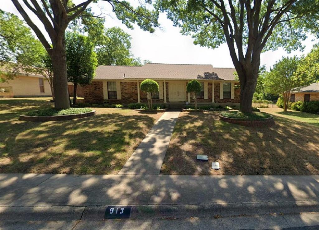 Ranch-style home featuring a front lawn