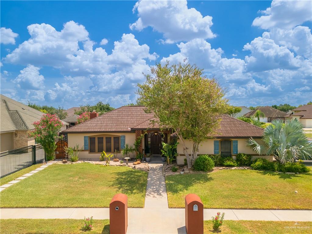 a front view of house with yard and trees