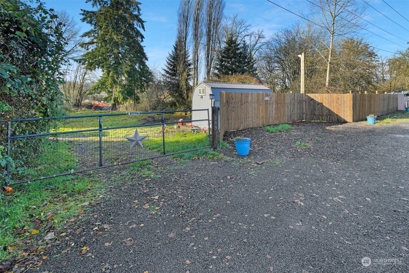 a view of backyard with wooden fence