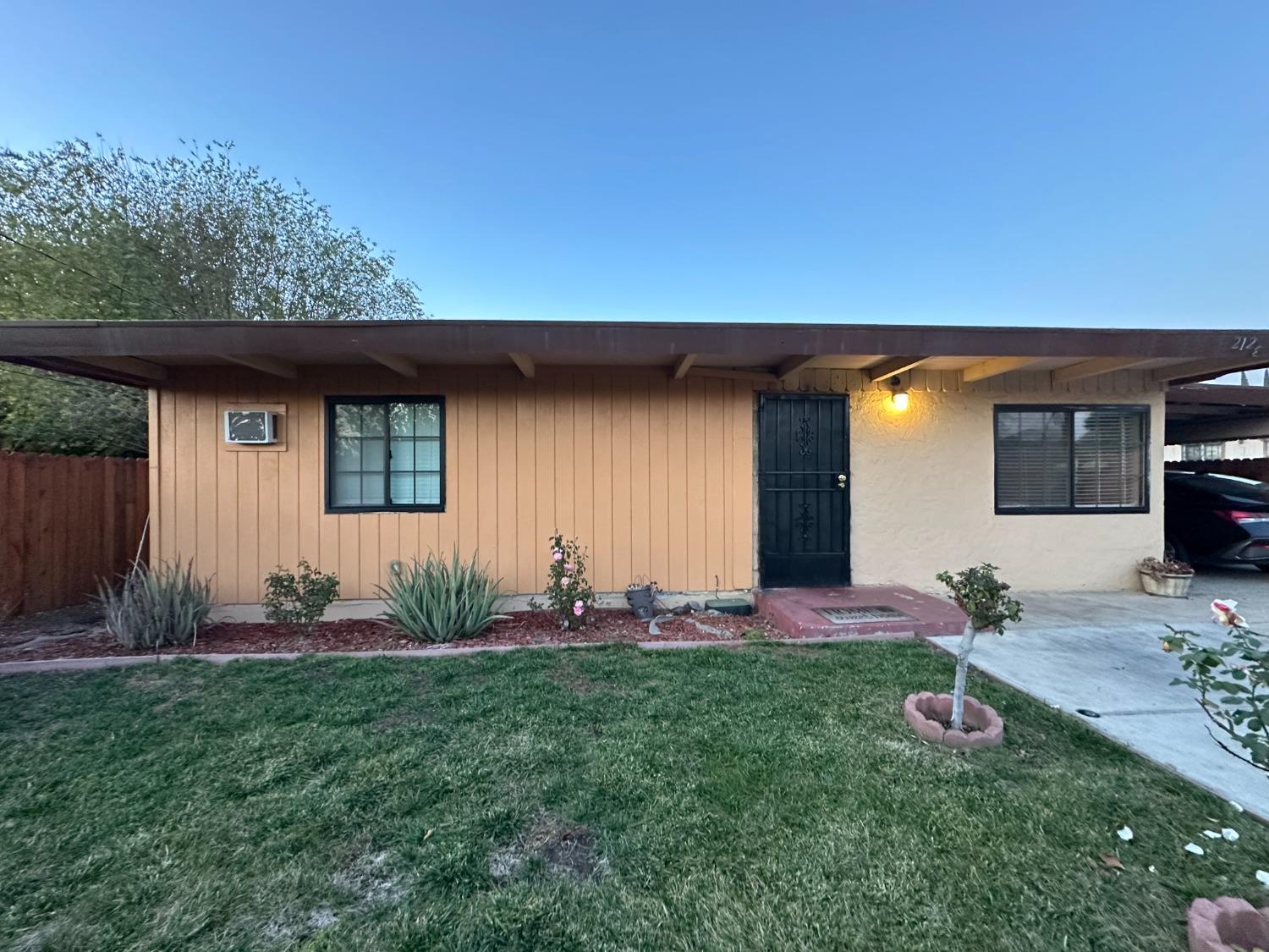 a front view of house with yard and seating space