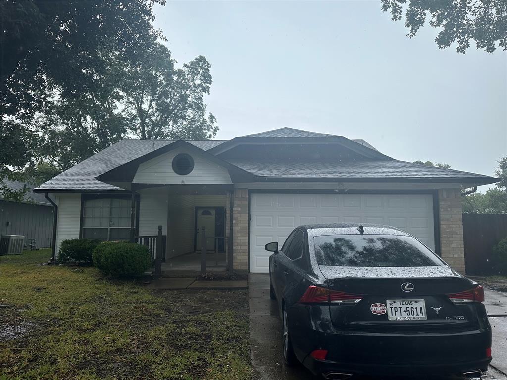 a front view of house with yard and trees around