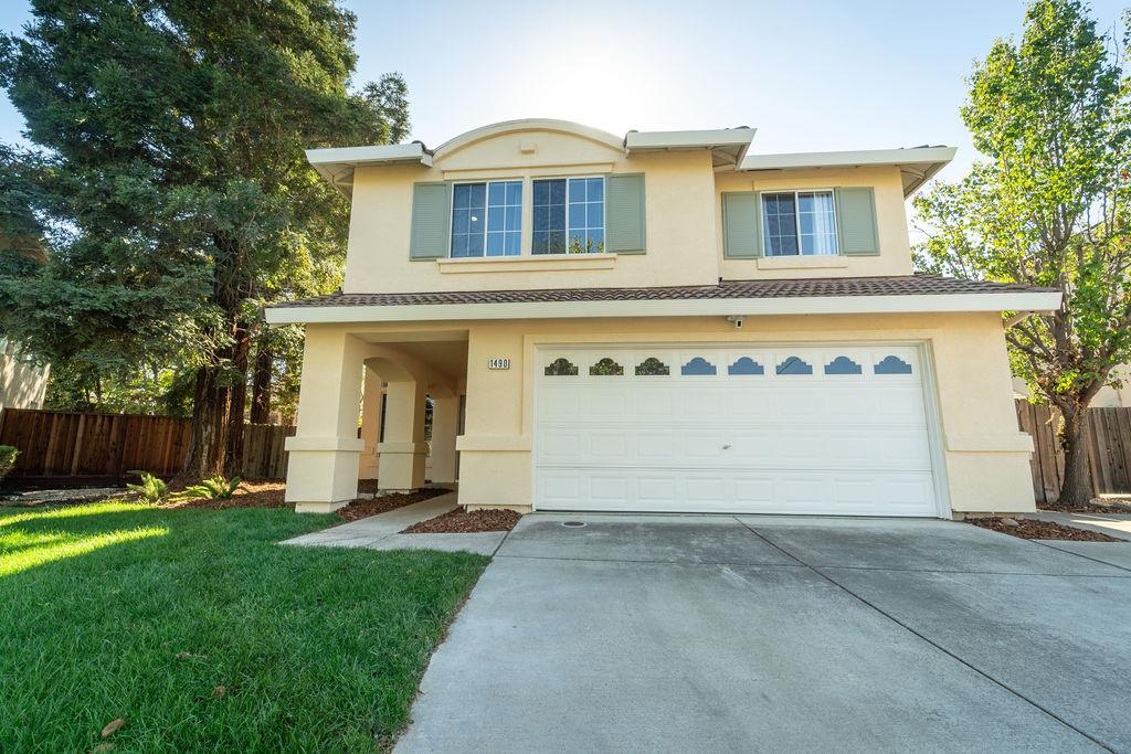 a front view of a house with a yard and garage