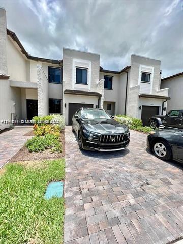 a view of a house with car parked beside of it