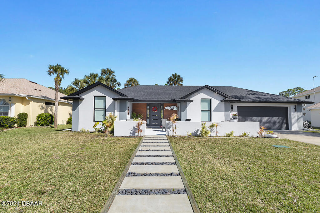 a front view of a house with a yard