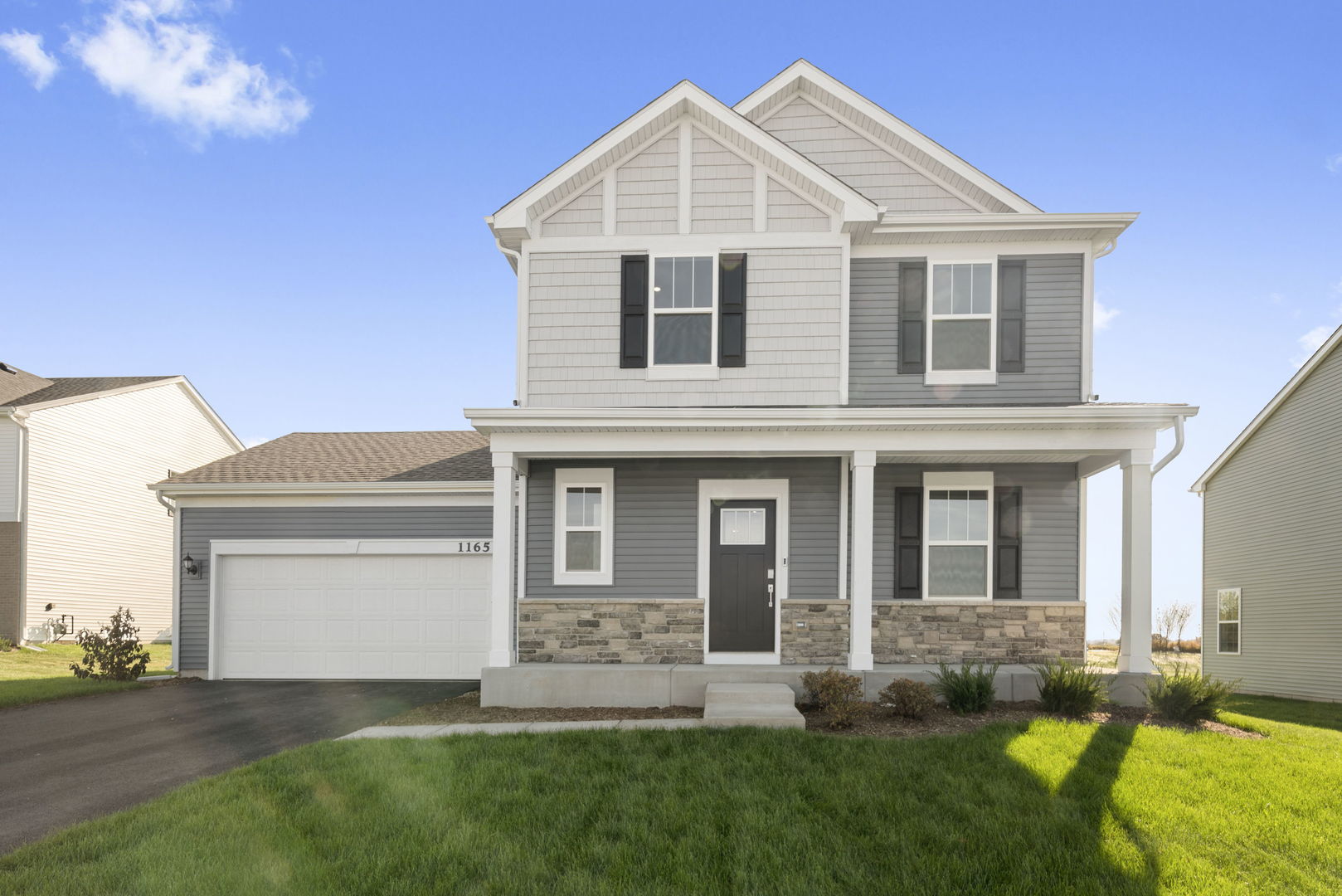 a front view of a house with a yard and porch