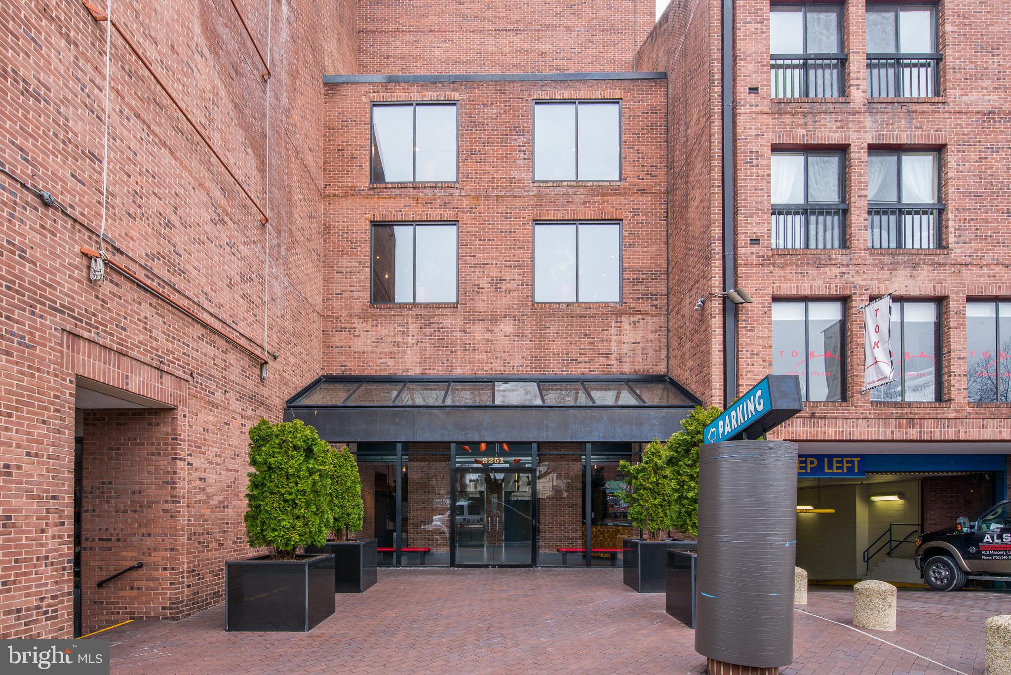 a view of a brick building with many windows