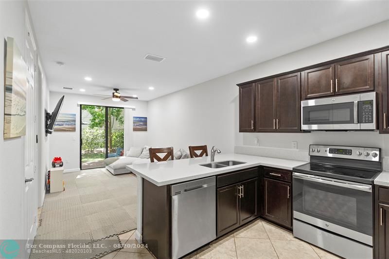 a kitchen that has a sink and a stove