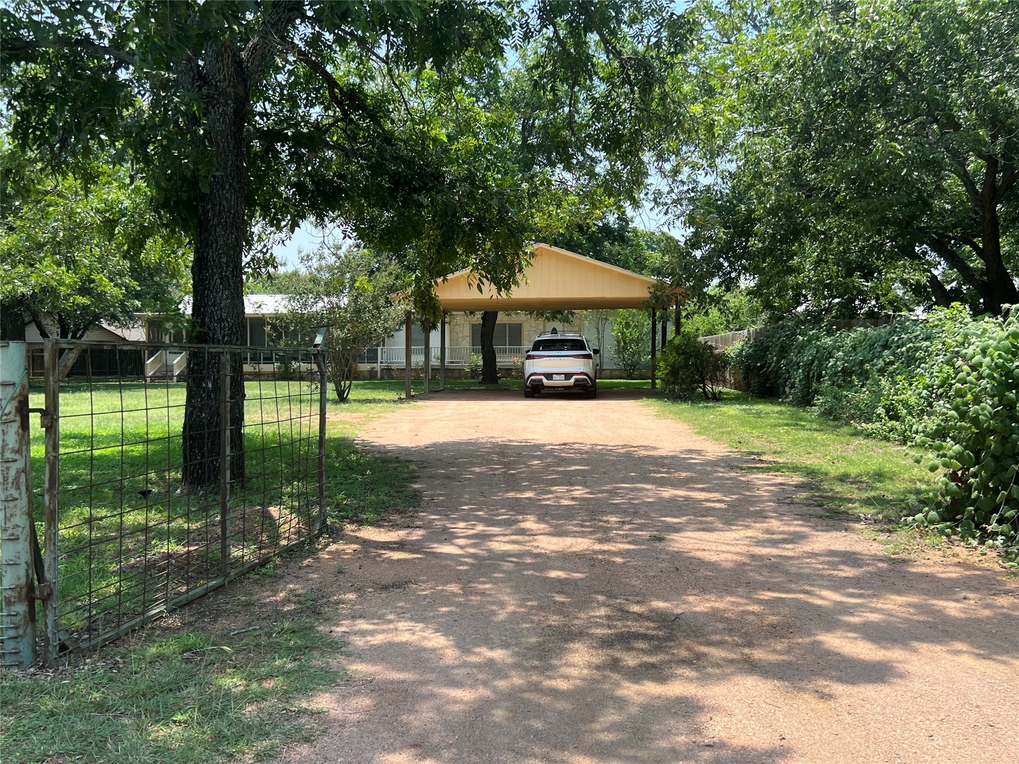 a front view of a house with a yard and trees