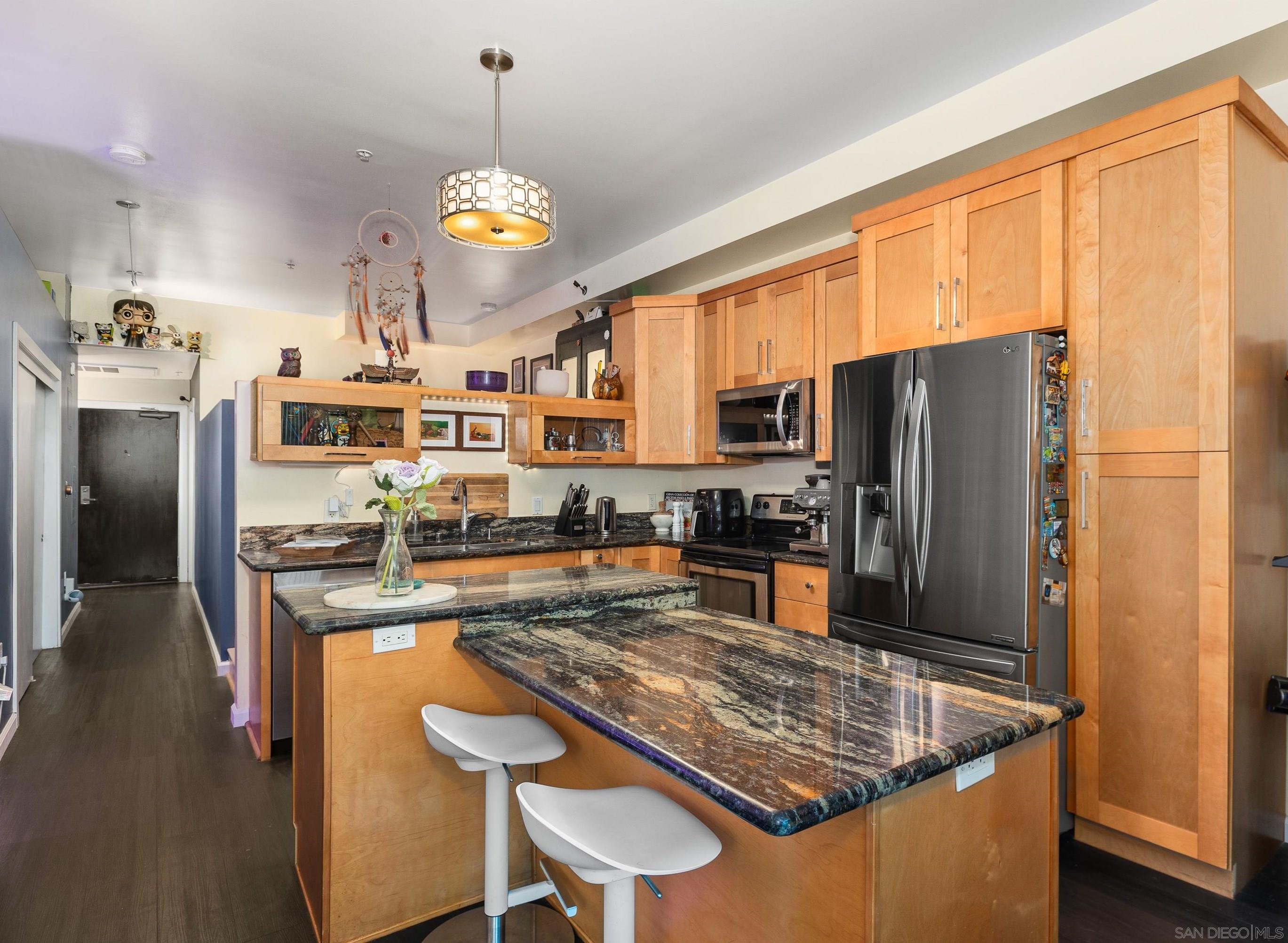 a kitchen with stainless steel appliances granite countertop a sink a stove and a refrigerator