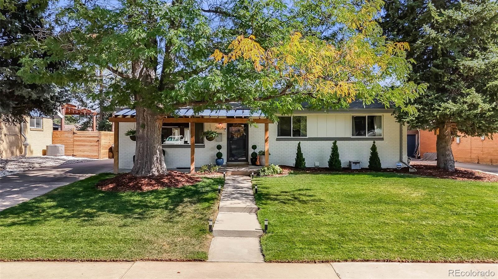 a front view of house with yard and trees