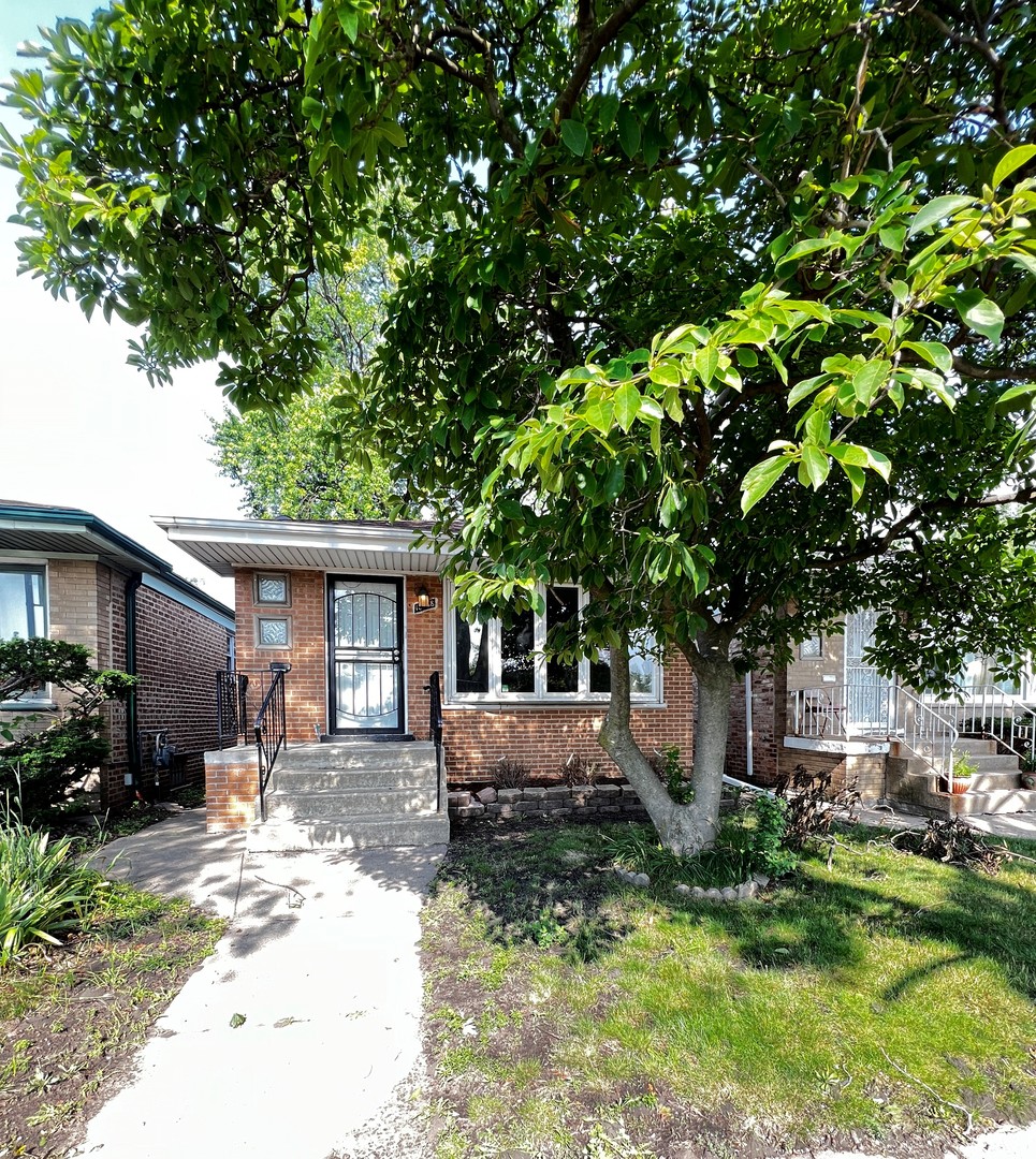 a front view of a house with a yard garage and outdoor seating