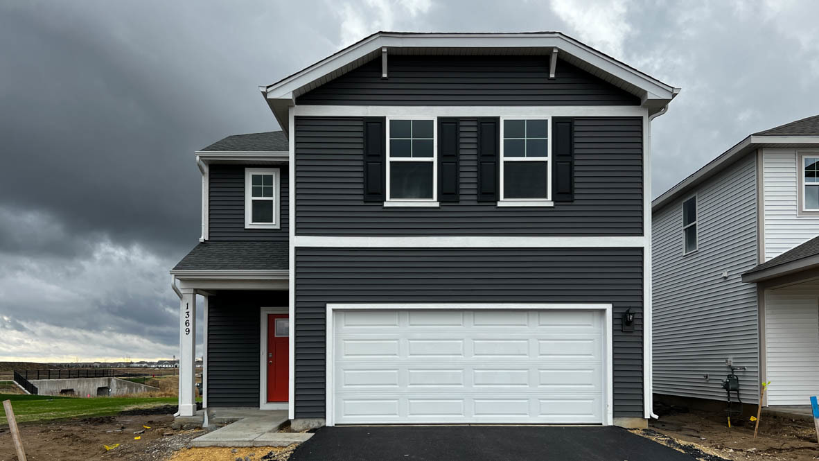 a front view of a house with a yard