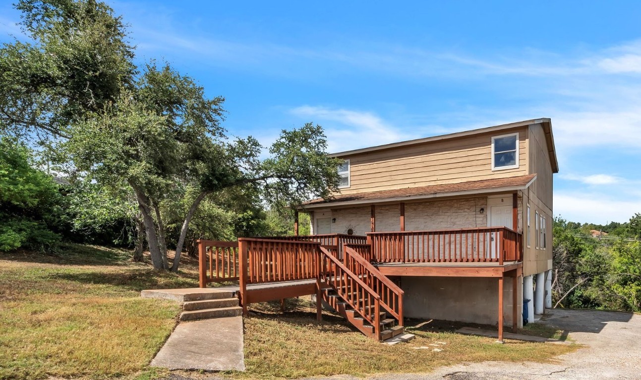 a view of backyard with deck and seating space