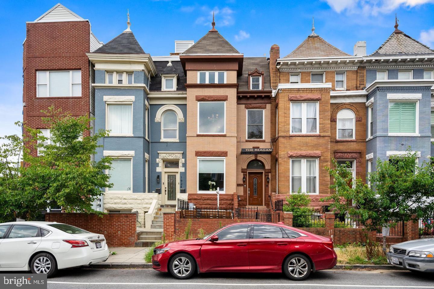 a front view of a residential apartment building with a yard