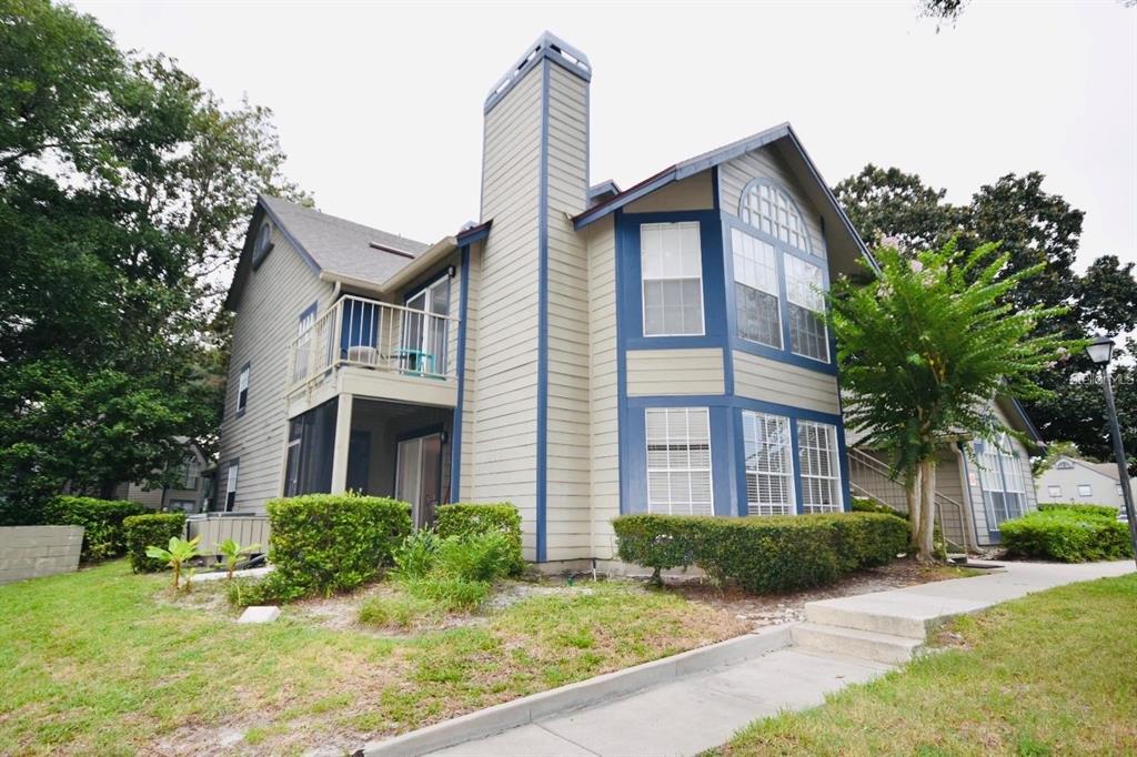 a front view of a house with garden and porch