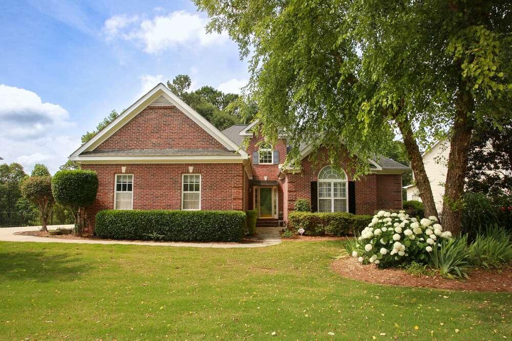 a front view of a house with a garden