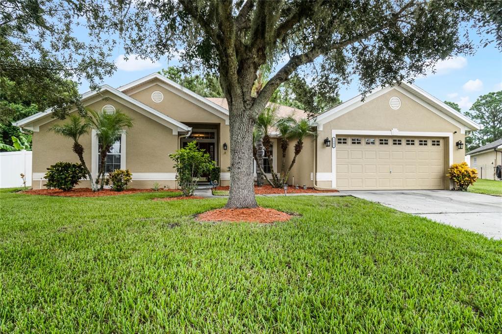 a front view of a house with a yard and garage