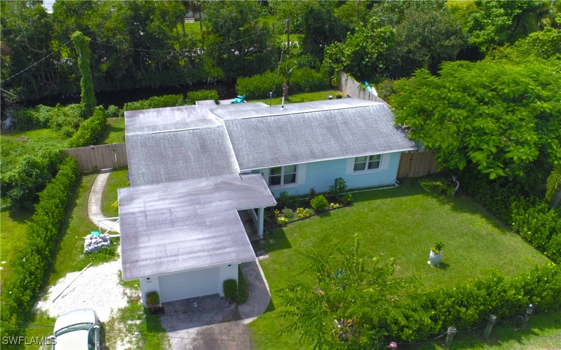 an aerial view of a house with garden space and street view