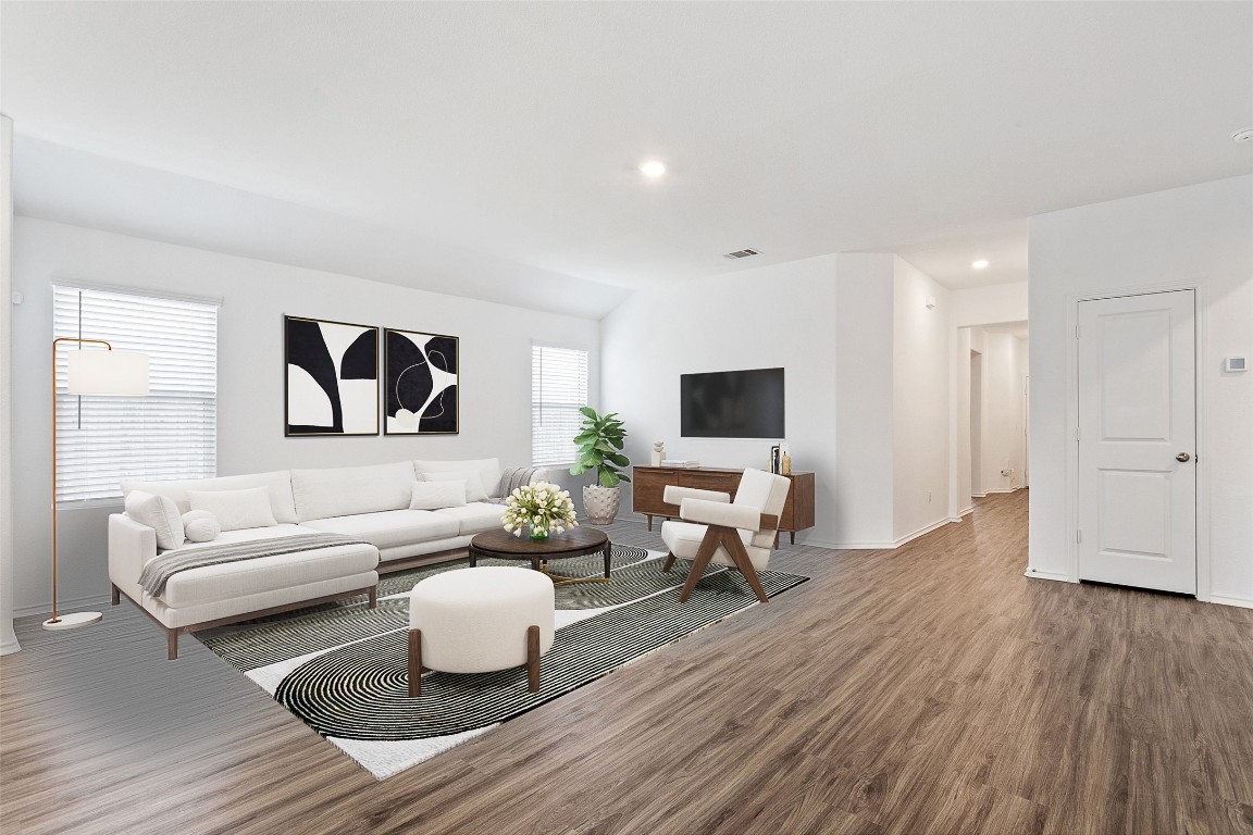 a living room with furniture wooden floor and a flat screen tv