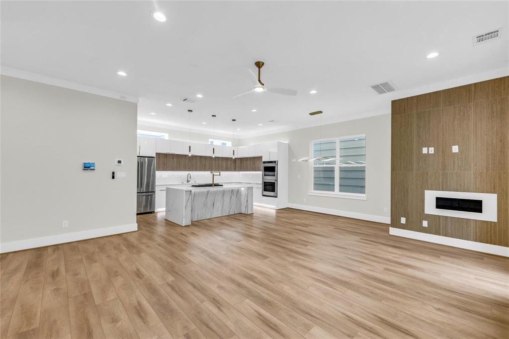 a view of a kitchen with wooden floor and windows