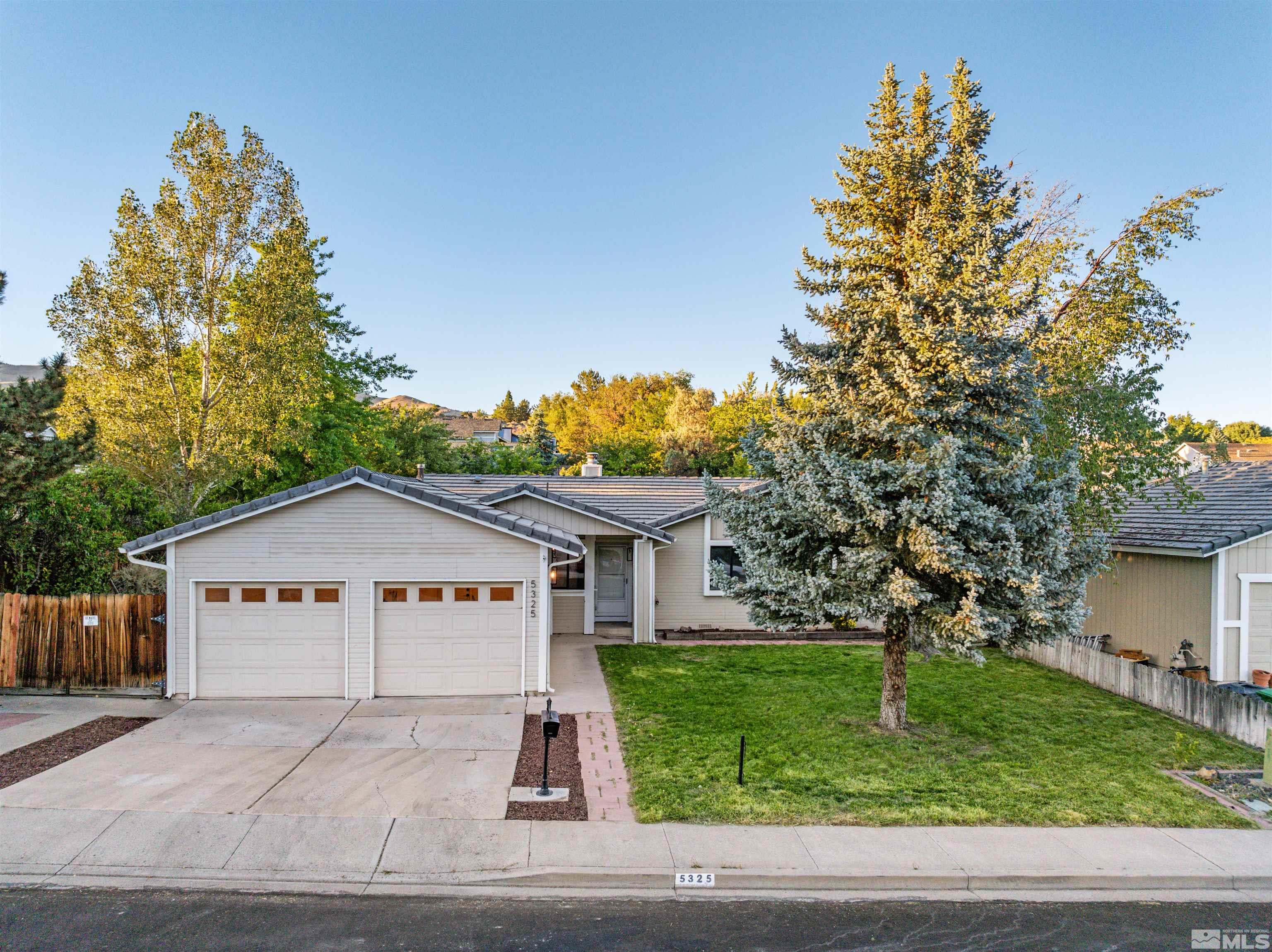 a view of a house with a yard and a garage