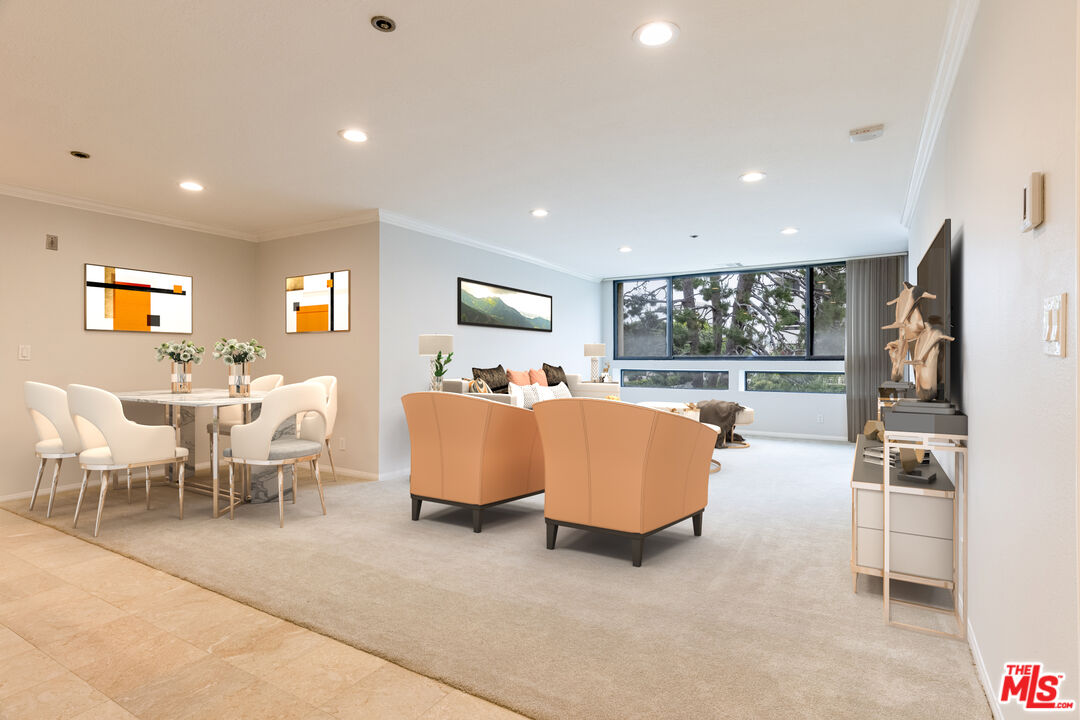 a living room with furniture kitchen view and a large window