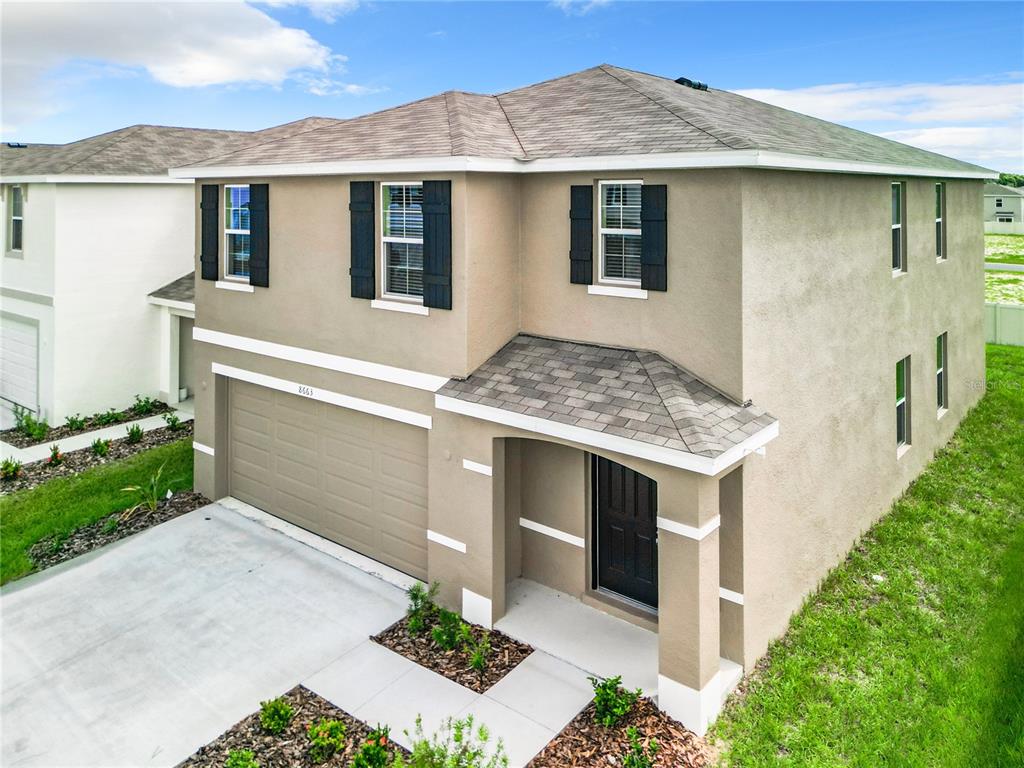 a front view of a house with garage