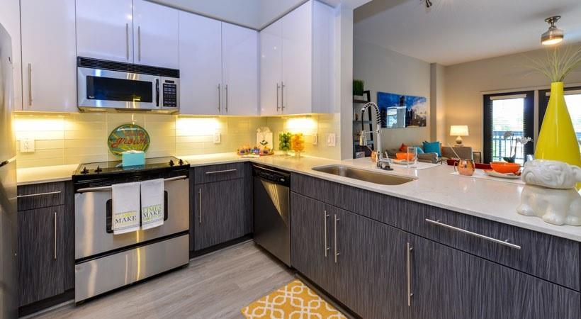 a kitchen with a sink stove and microwave