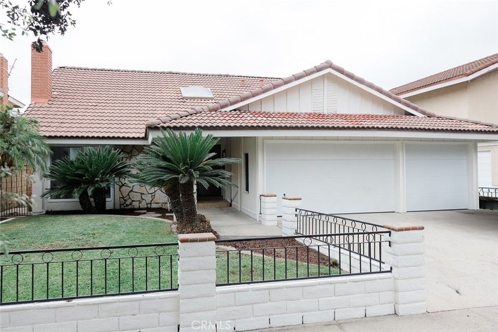 a view of a house with a small yard and plants